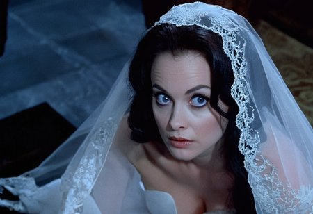 cinematic frame (close-up face:1.2) of a bride kneeling, face focus, from above, white lace veil, blue eyes, blank facial expression, detailed skin, photorealistic, soft light, creepy atmosphere, style of gothic horror films <lora:h4mm3r:0.8>
